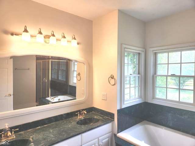 9909 E Mcgregor Rd, Indianapolis, IN 46259 - full bath featuring a garden tub, double vanity, and a shower stall