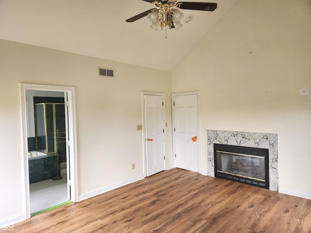 9909 E Mcgregor Rd, Indianapolis, IN 46259 - unfurnished living room featuring a ceiling fan, wood finished floors, high vaulted ceiling, and a fireplace