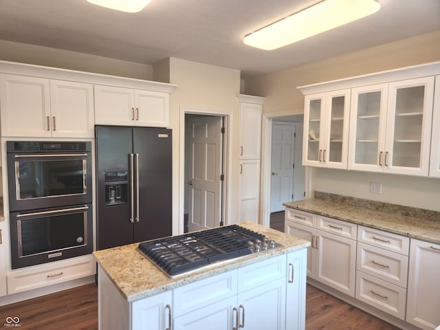 9909 E Mcgregor Rd, Indianapolis, IN 46259 - kitchen with high quality fridge, double oven, stainless steel gas stovetop, white cabinets, and glass insert cabinets