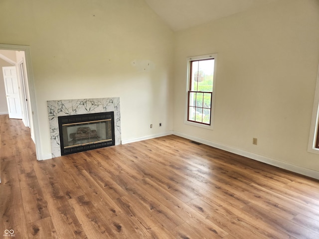 9909 E Mcgregor Rd, Indianapolis, IN 46259 - unfurnished living room with hardwood / wood-style floors, a high end fireplace, baseboards, and high vaulted ceiling