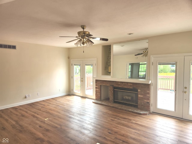 9909 E Mcgregor Rd, Indianapolis, IN 46259 - unfurnished living room with french doors, wood-type flooring, a fireplace, ceiling fan, and baseboards