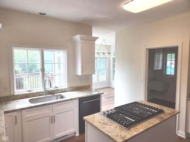9909 E Mcgregor Rd, Indianapolis, IN 46259 - kitchen featuring a sink, stainless steel gas stovetop, dishwashing machine, white cabinetry, and light stone counters