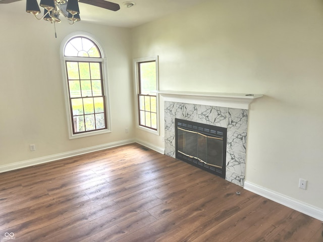 9909 E Mcgregor Rd, Indianapolis, IN 46259 - unfurnished living room with wood-type flooring, a glass covered fireplace, baseboards, and a ceiling fan