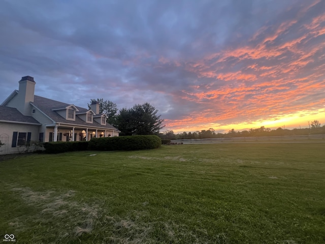 9909 E Mcgregor Rd, Indianapolis, IN 46259 - yard at dusk featuring a lawn