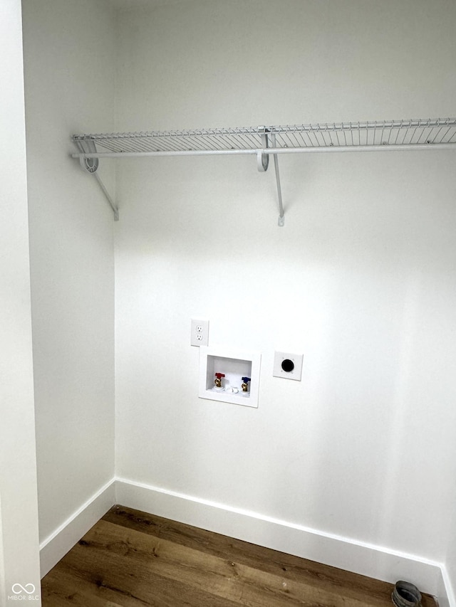 washroom with baseboards, dark wood-style flooring, washer hookup, hookup for an electric dryer, and laundry area
