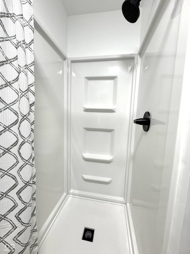 bathroom with a shower stall