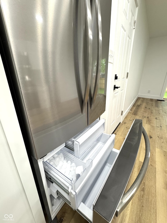 interior space with baseboards and wood finished floors