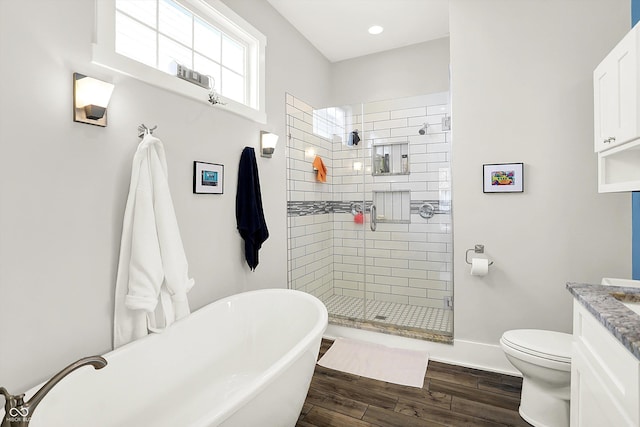 829 Olive St, Indianapolis, IN 46203 - full bathroom featuring wood finished floors, a stall shower, vanity, toilet, and a freestanding bath