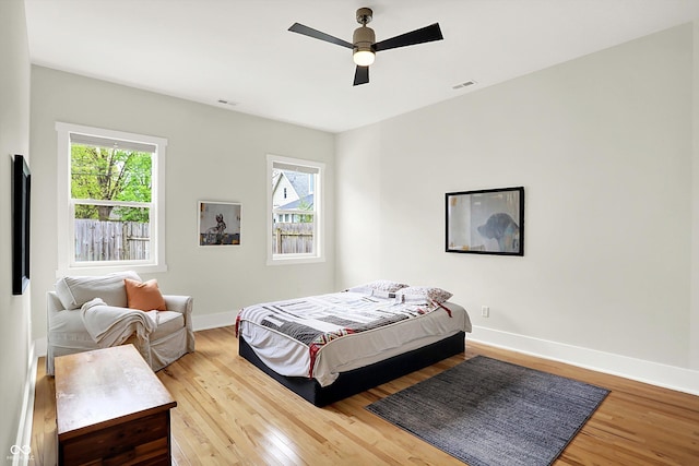 829 Olive St, Indianapolis, IN 46203 - bedroom with wood finished floors, baseboards, and ceiling fan
