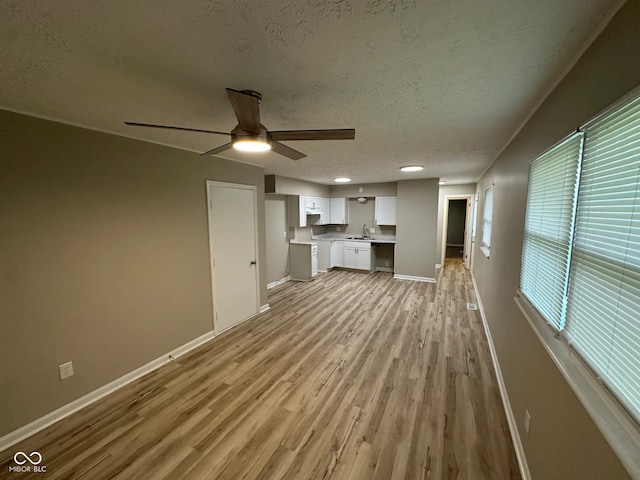 2453 Larnie Ln, Indianapolis, IN 46219 - unfurnished living room with light wood-style floors, a ceiling fan, and a textured ceiling