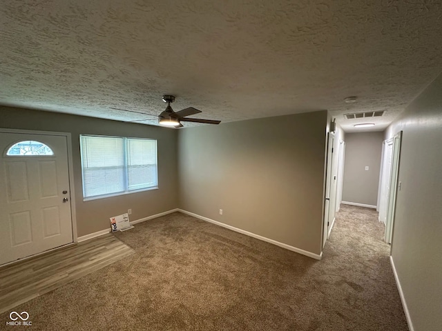 2453 Larnie Ln, Indianapolis, IN 46219 - carpeted entryway with a ceiling fan and a textured ceiling