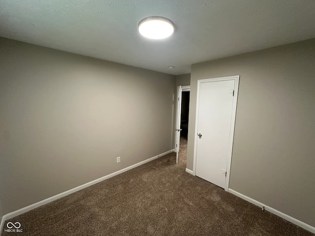 2453 Larnie Ln, Indianapolis, IN 46219 - unfurnished bedroom featuring dark colored carpet and baseboards