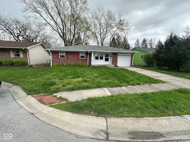 2453 Larnie Ln, Indianapolis, IN 46219 - single story home featuring brick siding, an attached garage, driveway, and a front lawn