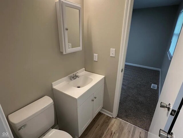 2453 Larnie Ln, Indianapolis, IN 46219 - half bath featuring vanity and wood finished floors