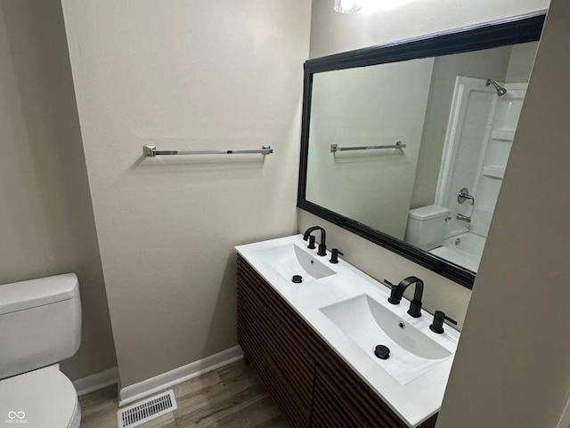 2453 Larnie Ln, Indianapolis, IN 46219 - bathroom featuring wood finished floors, double vanity, and shower / tub combination