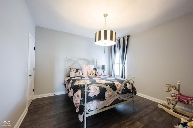 bedroom with wood finished floors and baseboards