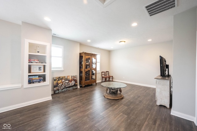 sitting room featuring dark wood-type flooring, recessed lighting, and baseboards