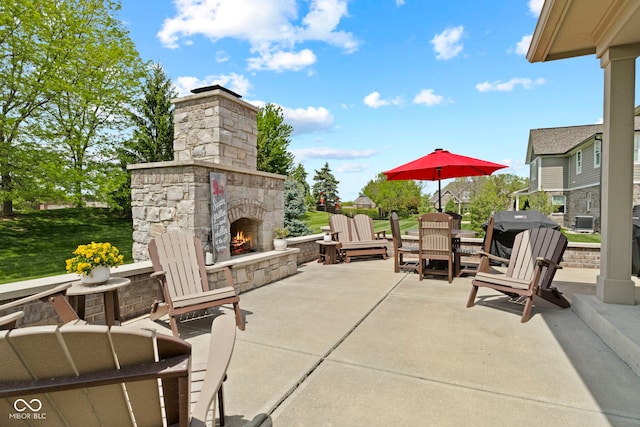 view of patio / terrace featuring an outdoor stone fireplace