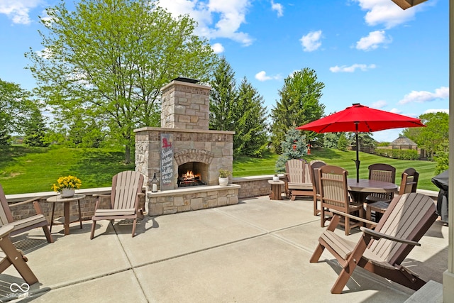view of patio with an outdoor stone fireplace