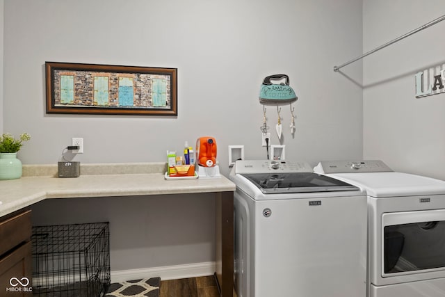 laundry area with independent washer and dryer, laundry area, baseboards, and dark wood-type flooring