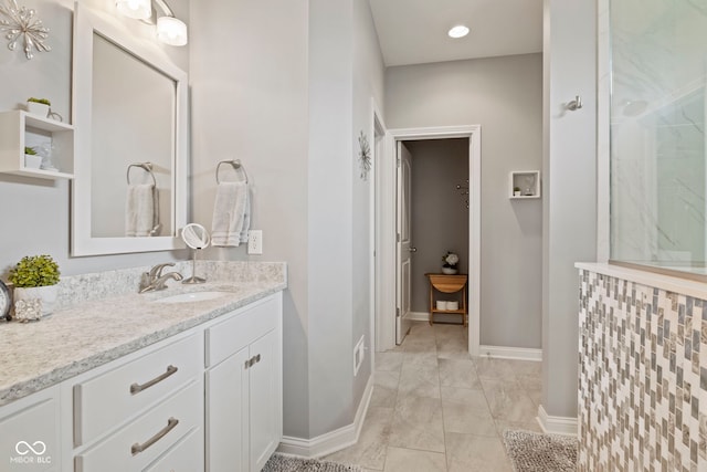 bathroom featuring walk in shower, baseboards, vanity, and marble finish floor