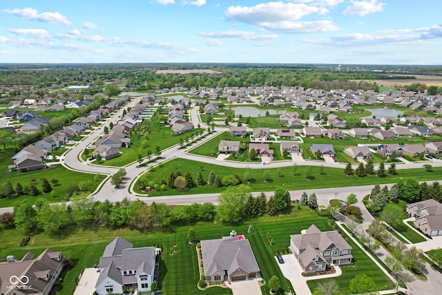 drone / aerial view with a water view and a residential view