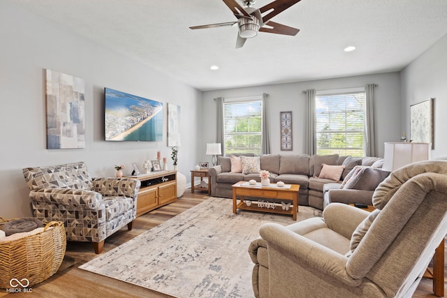 living area featuring ceiling fan, recessed lighting, and wood finished floors