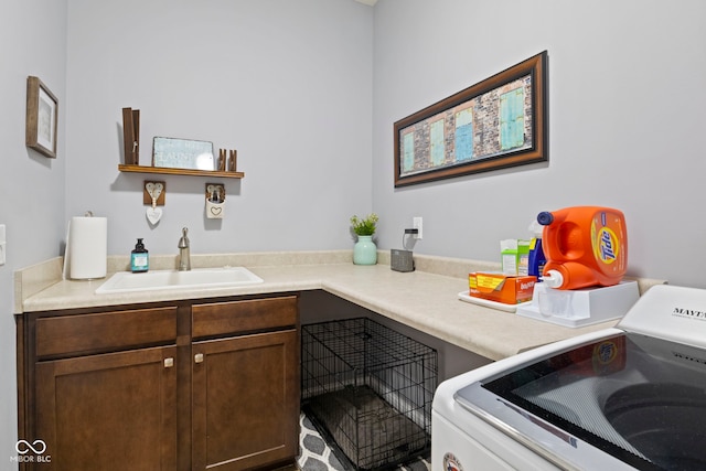 laundry area with a sink and washer / clothes dryer