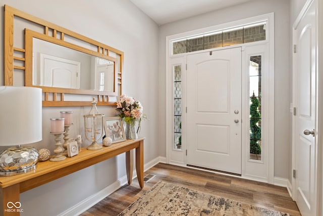entrance foyer with baseboards, visible vents, and wood finished floors