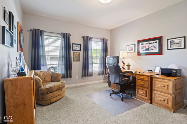 carpeted office featuring baseboards