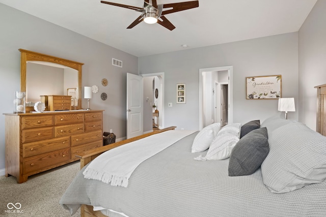 bedroom with a ceiling fan, light colored carpet, and visible vents