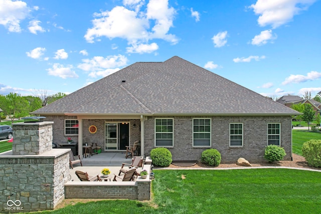 back of property with roof with shingles, a yard, a patio area, and brick siding