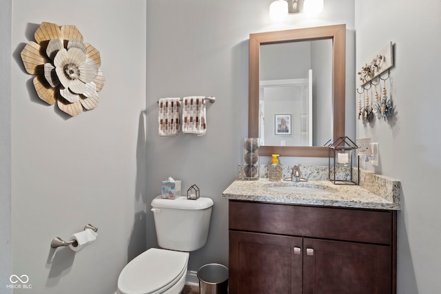 bathroom with toilet and vanity