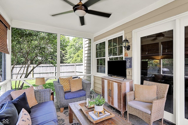 sunroom / solarium featuring ceiling fan and an outdoor living space