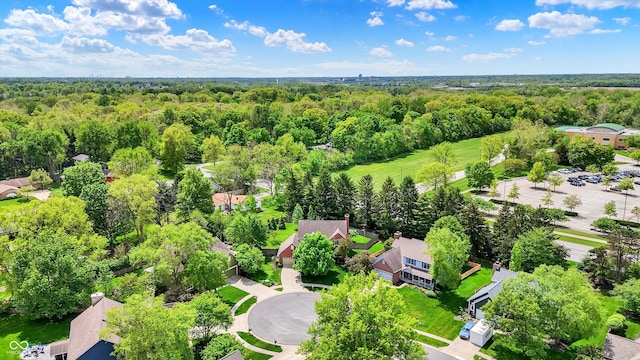 aerial perspective of suburban area featuring a heavily wooded area