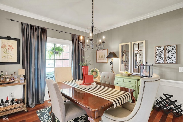 dining space with a chandelier, wood finished floors, and crown molding