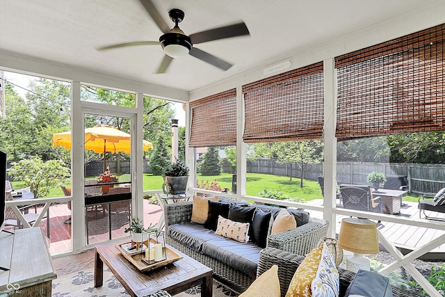 sunroom featuring outdoor lounge area, a ceiling fan, and healthy amount of natural light