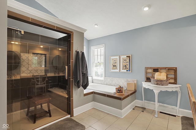 full bath featuring tile patterned flooring, a stall shower, and a bath