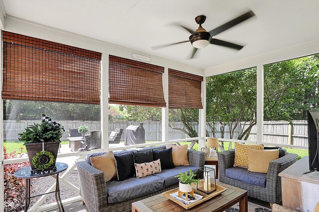 sunroom with outdoor lounge area, ceiling fan, and healthy amount of natural light