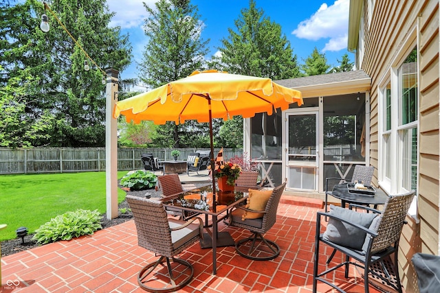 view of patio featuring a sunroom and outdoor dining space