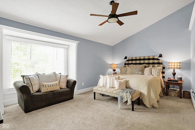 carpeted bedroom with lofted ceiling, baseboards, and a ceiling fan