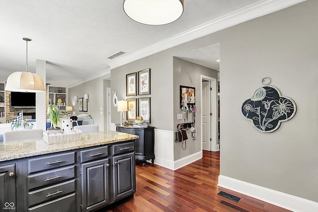 kitchen with dark wood-type flooring, ornamental molding, open floor plan, light stone countertops, and baseboards