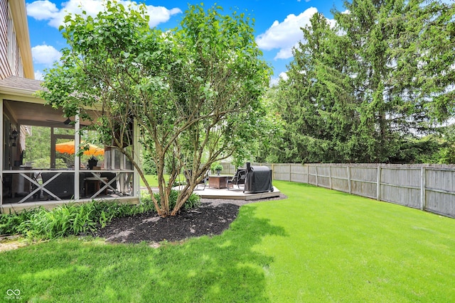 view of yard featuring a sunroom and a wooden deck