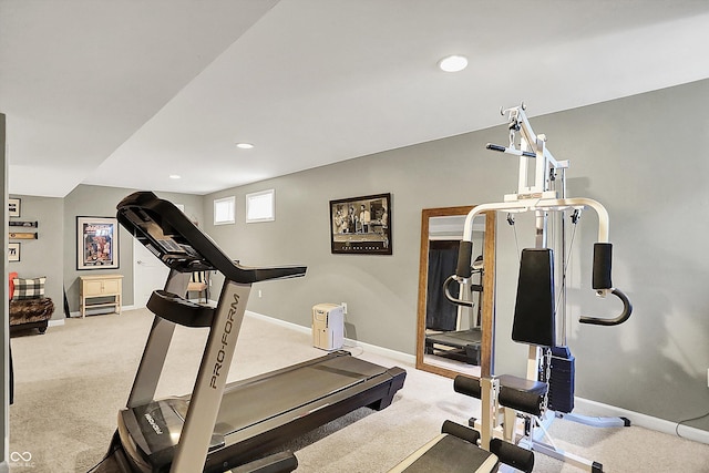 exercise area with baseboards, light colored carpet, and recessed lighting