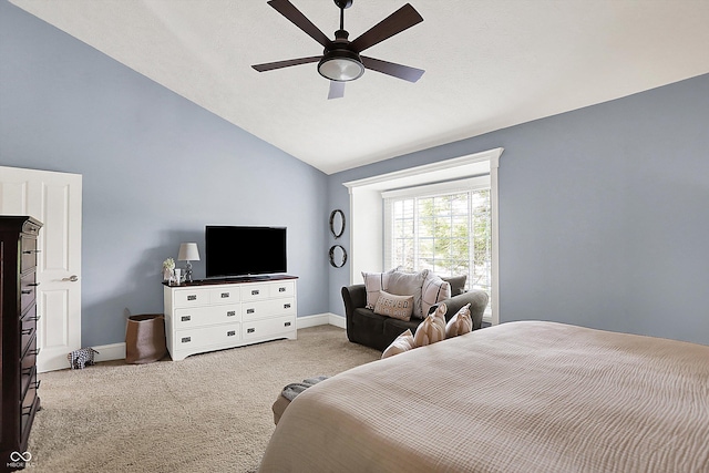 bedroom featuring carpet floors, vaulted ceiling, baseboards, and a ceiling fan