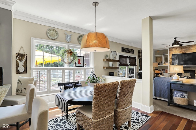 dining room with a ceiling fan, wood-type flooring, crown molding, and built in shelves