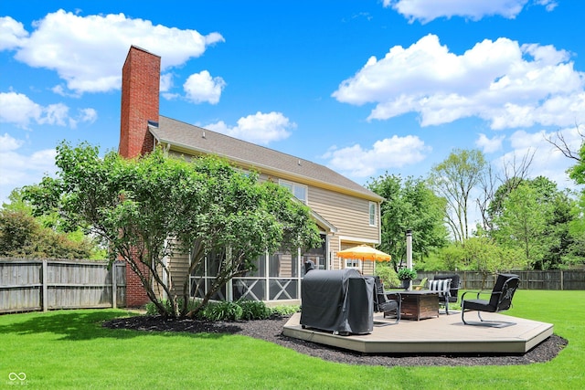 back of house with a deck and a chimney