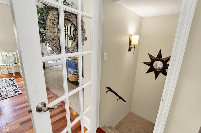 stairway featuring wood finished floors