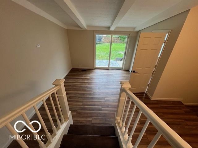 223 E Fordice St, Lebanon, IN 46052 - staircase featuring baseboards, beam ceiling, and wood finished floors