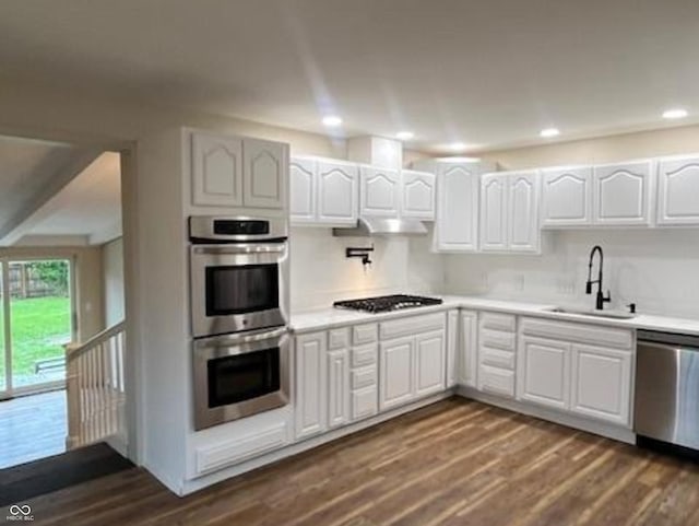 223 E Fordice St, Lebanon, IN 46052 - kitchen featuring a sink, dark wood-type flooring, light countertops, white cabinets, and appliances with stainless steel finishes